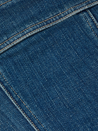 Close-up of the Lorda Dress in blue stretch denim fabric, highlighting detailed stitching, textured material, visible seams, and yellowish thread.