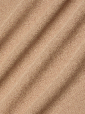 A close-up of light beige poly georgette fabric with soft diagonal folds and gentle shadows, as featured in the Raye Slip Lining Dress.