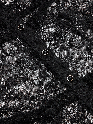 Close-up of sheer lace with a floral pattern and a diagonal strip of four silver snap buttons—perfect for adding Seraphina flair to the Lace Tiered Maxi Dress.