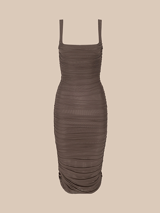 The Anya Shirred Dress is a sleeveless, fitted brown dress with ruched detailing, a square neckline, and a knee-length hem. It features a lined zip closure and is displayed on a plain beige background.