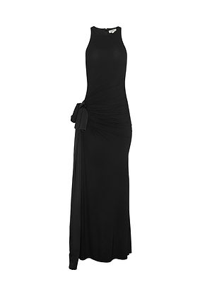 The Frost Shirred Gown is a sleeveless black maxi with a high neckline, fitted bodice, and draped gathered detail with a side bow—timeless elegance from Fall 2026 New York Fashion Week, ideal for channeling historical romance.