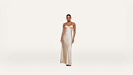 A woman wearing a long, cream-colored satin slip dress stands against a plain white background, facing forward with a neutral expression.