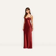 A woman wearing a floor-length, sleeveless maroon Sayla Silk Gown featuring a vintage glamour corset-style bodice.