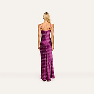 A person with long blonde hair is seen from the back, standing against a plain background, wearing the Sayla Silk Gown—a sleeveless, floor-length purple dress adorned with white polka dots, perfect for special events.