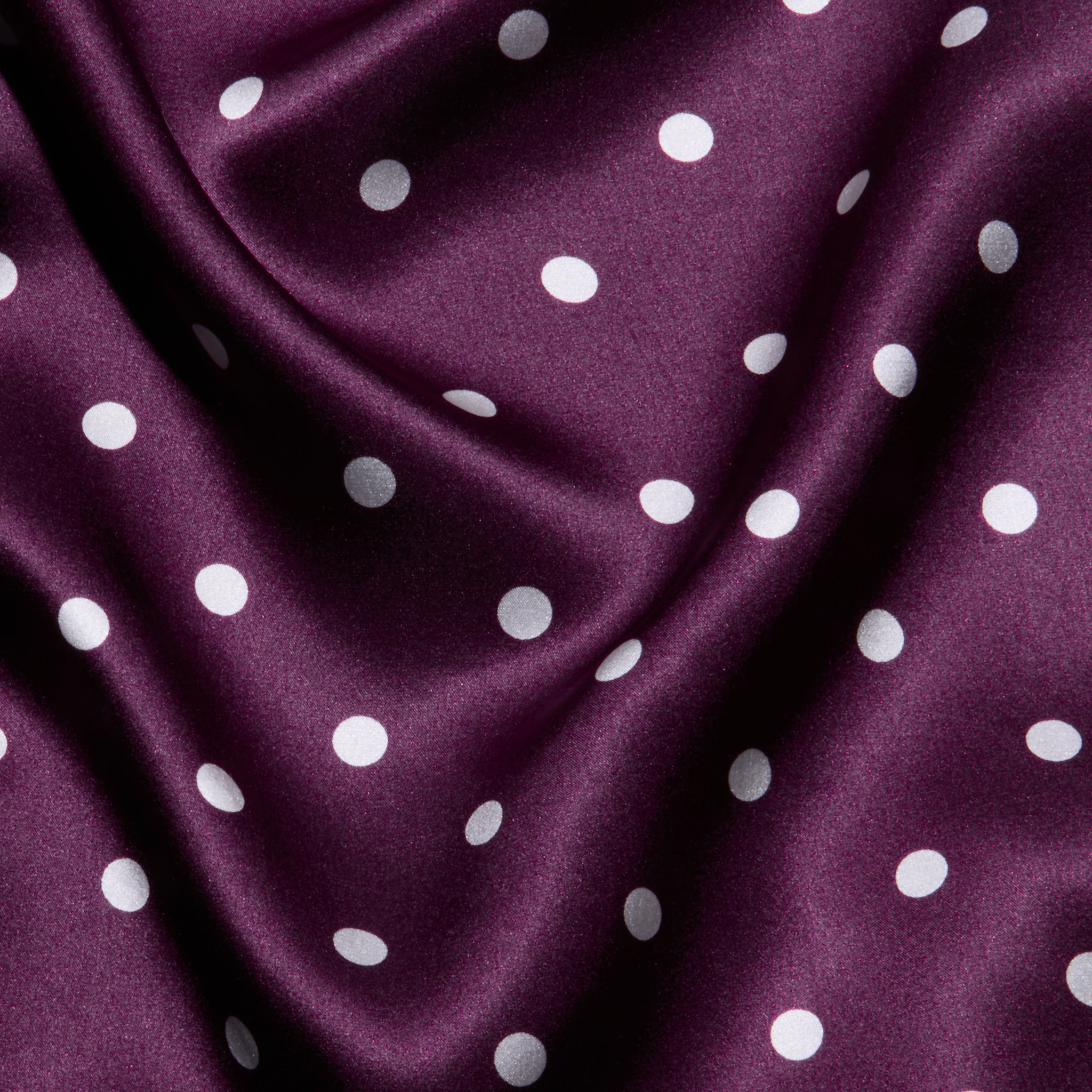 Sayla Silk Gown crafted from purple satin adorned with white polka dots, featuring gentle folds and a soft, smooth texture—perfect for a vintage glamour look or an event-ready dress.