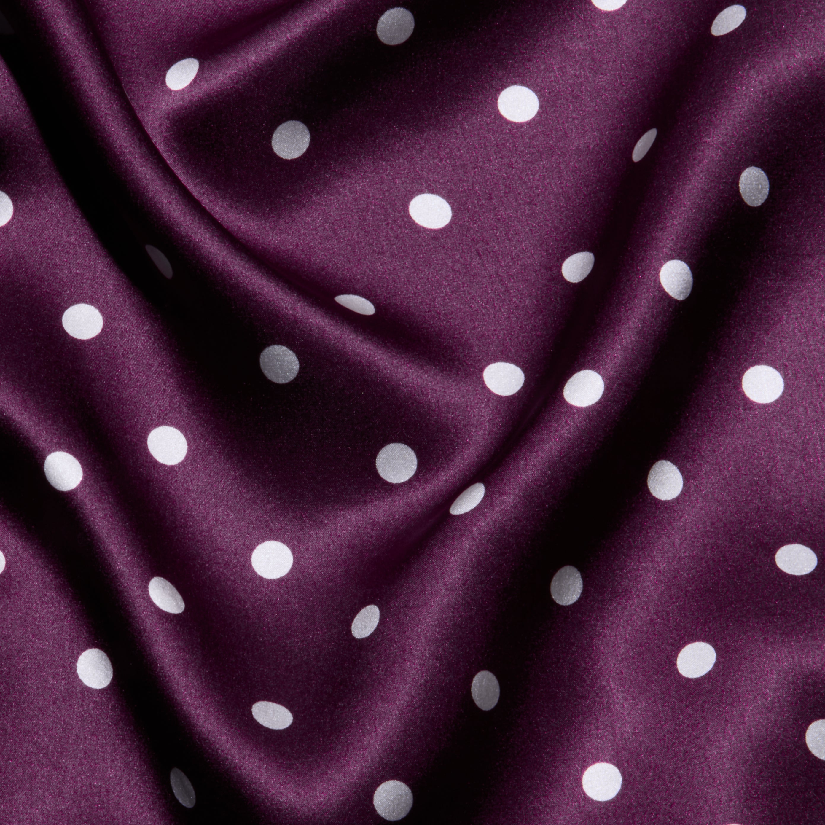 Sayla Silk Gown crafted from purple satin adorned with white polka dots, featuring gentle folds and a soft, smooth texture—perfect for a vintage glamour look or an event-ready dress.