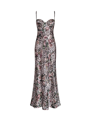 The Sayla Silk Gown is a sleeveless, floor-length slip dress with thin spaghetti straps and a rose cheetah print on a light background, exuding vintage glamour.
