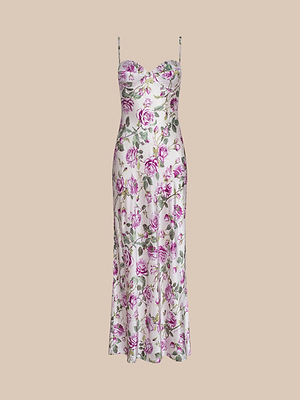 The Sayla Silk Gown is a sleeveless, midi-length dress with thin straps and a sweetheart neckline, featuring a white base with pink and green rose florals, shown against a beige background.