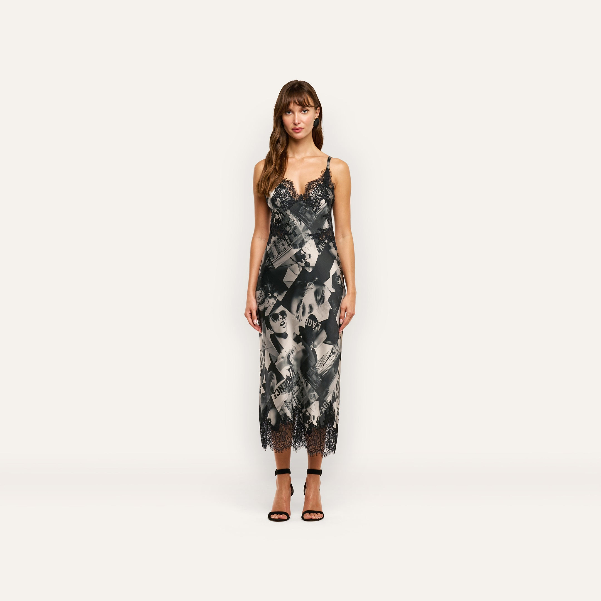 Victoire Silk Dress in a midi-length slip style featuring a black-and-white magazine print with black lace trim at the neckline and hem.