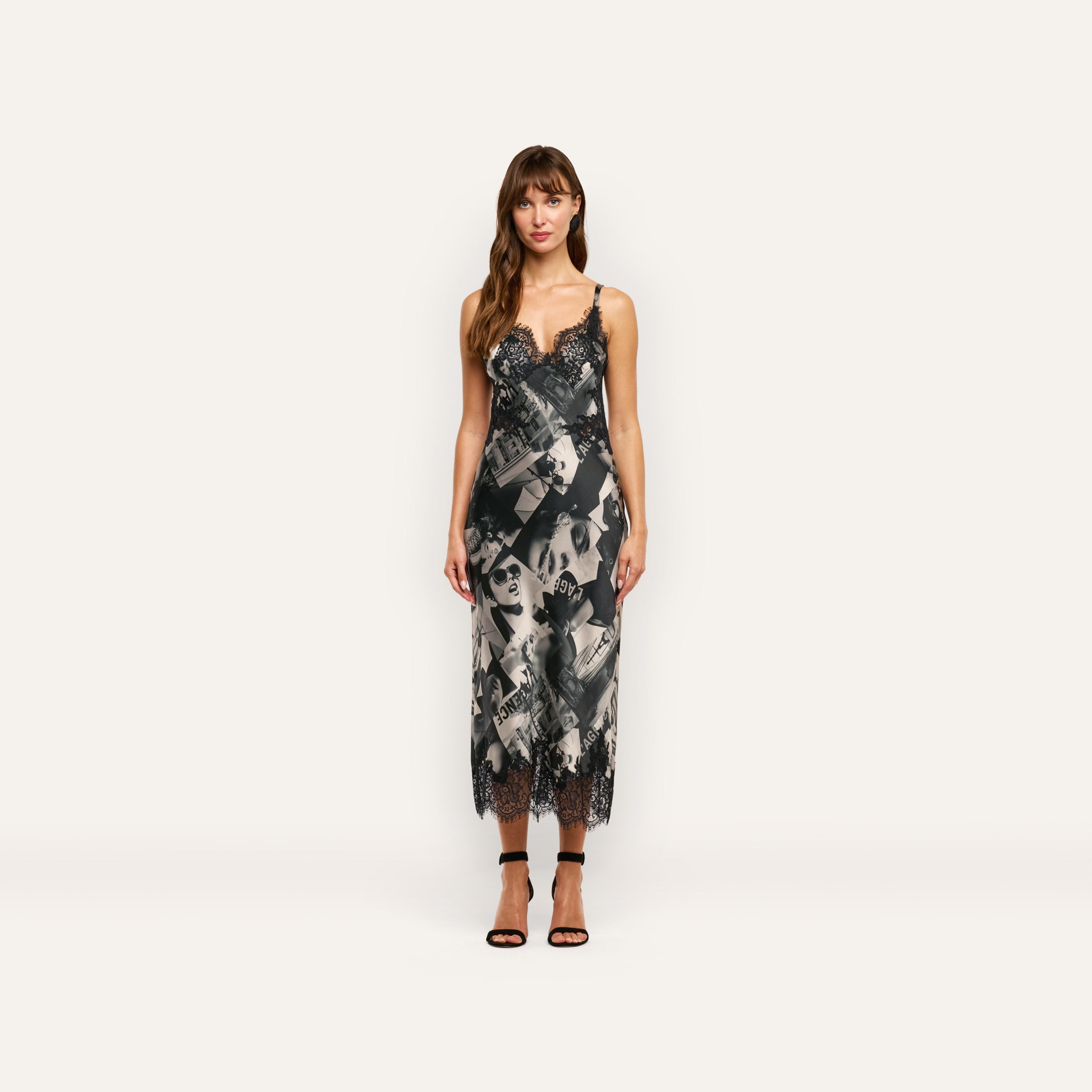 Victoire Silk Dress in a midi-length slip style featuring a black-and-white magazine print with black lace trim at the neckline and hem.