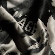 Victoire Silk Dress in black and white silk, featuring the word LÂGE in large capital letters and a delicate lace trim.