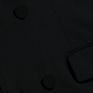 Vale Tuxedo Dress, a black maxi dress styled like a tuxedo jacket with fabric-covered buttons and a flap pocket.