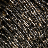 Close-up of rows of metallic dark gray beaded fringe on the halter neckline of the Niobe Fringe Dress.