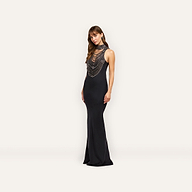 A model wears the Yuan Embellished Gown, a floor-length black satin maxi dress featuring a high, crystal-embellished halter neckline with tiered beaded fringe.