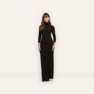 A woman wearing the black turtleneck Jaesyn Dress with three-quarter length sleeves.