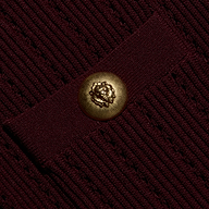 Close-up of the burgundy Irvin Pointelle Knit Cardigan, featuring a round, gold-toned button embossed with a lion head.