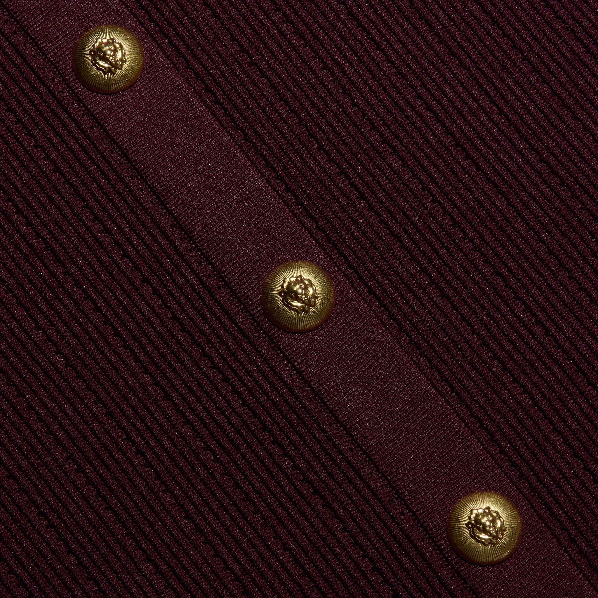 Melania Pointelle Knit Skirt in deep burgundy, featuring a vertical placket with three gold lion-embossed buttons.