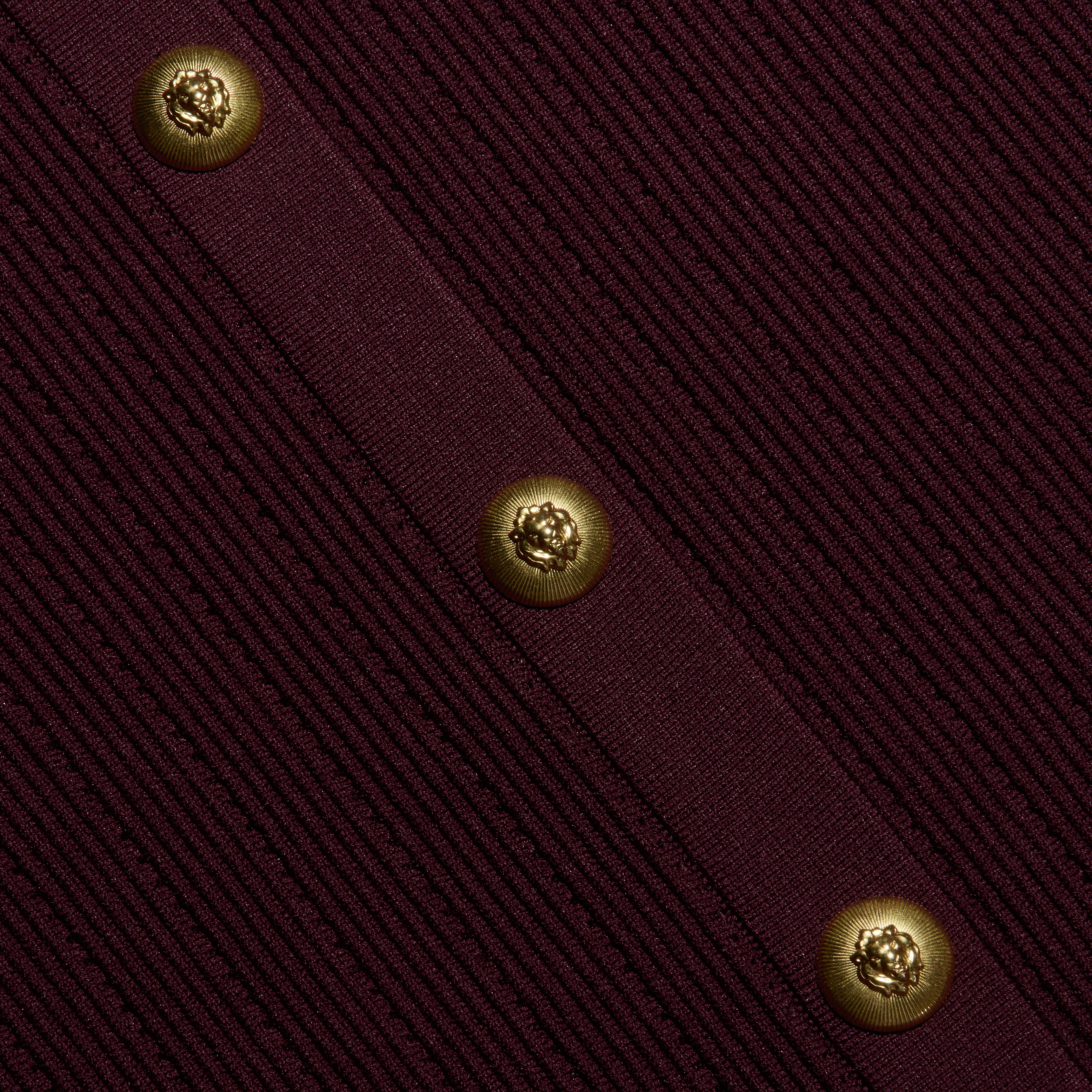 Melania Pointelle Knit Skirt in deep burgundy, featuring a vertical placket with three gold lion-embossed buttons.