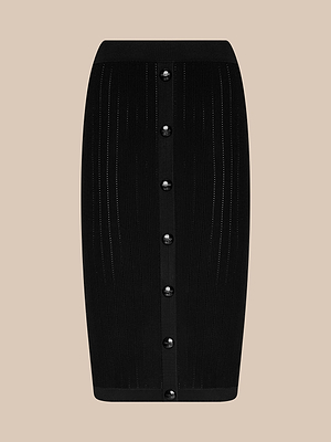 The Melania Pointelle Knit Skirt is a black, knee-length pull-on pencil skirt with vertical ribbed details and front black buttons, shown on a beige background.