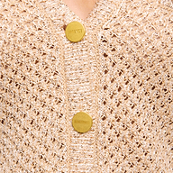 Close-up of the Blanca Sequin Cardigan—a neutral tan, lightweight layer featuring a textured open weave and two large gold buttons, with FRENCE engraved on the top button.