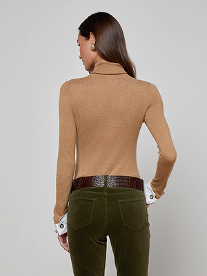 A woman wearing the Flora Turtleneck by L'AGENCE in brown silk.