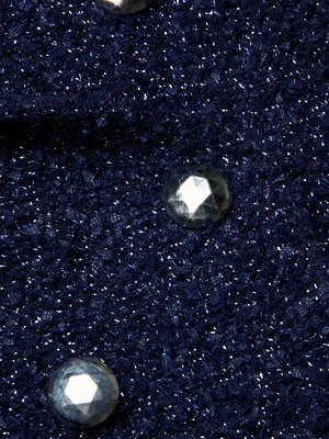 Close-up of the Bethany Knit Blazer in midnight blue, featuring a glittery knit fabric adorned with shiny, faceted silver buttons.