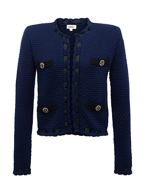The Astor Cardigan by L'AGENCE is a midnight blue textured knit with black trim, four front pockets accented by round buttons, and a round collarless neckline for Parisian-inspired style.