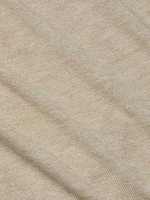 Close-up of the Kamdyn Cropped Sweater by L'AGENCE in light beige, featuring lightweight knit fabric with diagonal ribbed patterns that highlight its texture and weave.