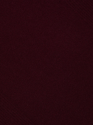 Close-up of the Larelle Midi Dress by L'AGENCE, showcasing its maroon, textured fabric with fine diagonal lines and a soft, woven look—ideal for a ribbed-knit or mock neck dress style.