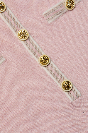 Close-up of the Masaki Cropped Sweater: a featherweight soft pink knit with diagonal white stripes and metallic gold buttons, perfect for a chic cropped look.