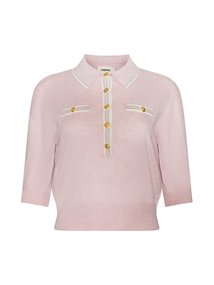 The Masaki Cropped Sweater is a light pink, featherweight knit polo with a white collar and trim, gold front buttons, and two chest pockets adorned with gold button accents.