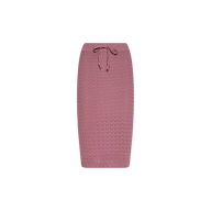 The Lacen Pointelle Knit Skirt is a mauve, breathable knit skirt featuring a textured zigzag pattern and a drawstring waist, cut to midi length and displayed on a plain white background.