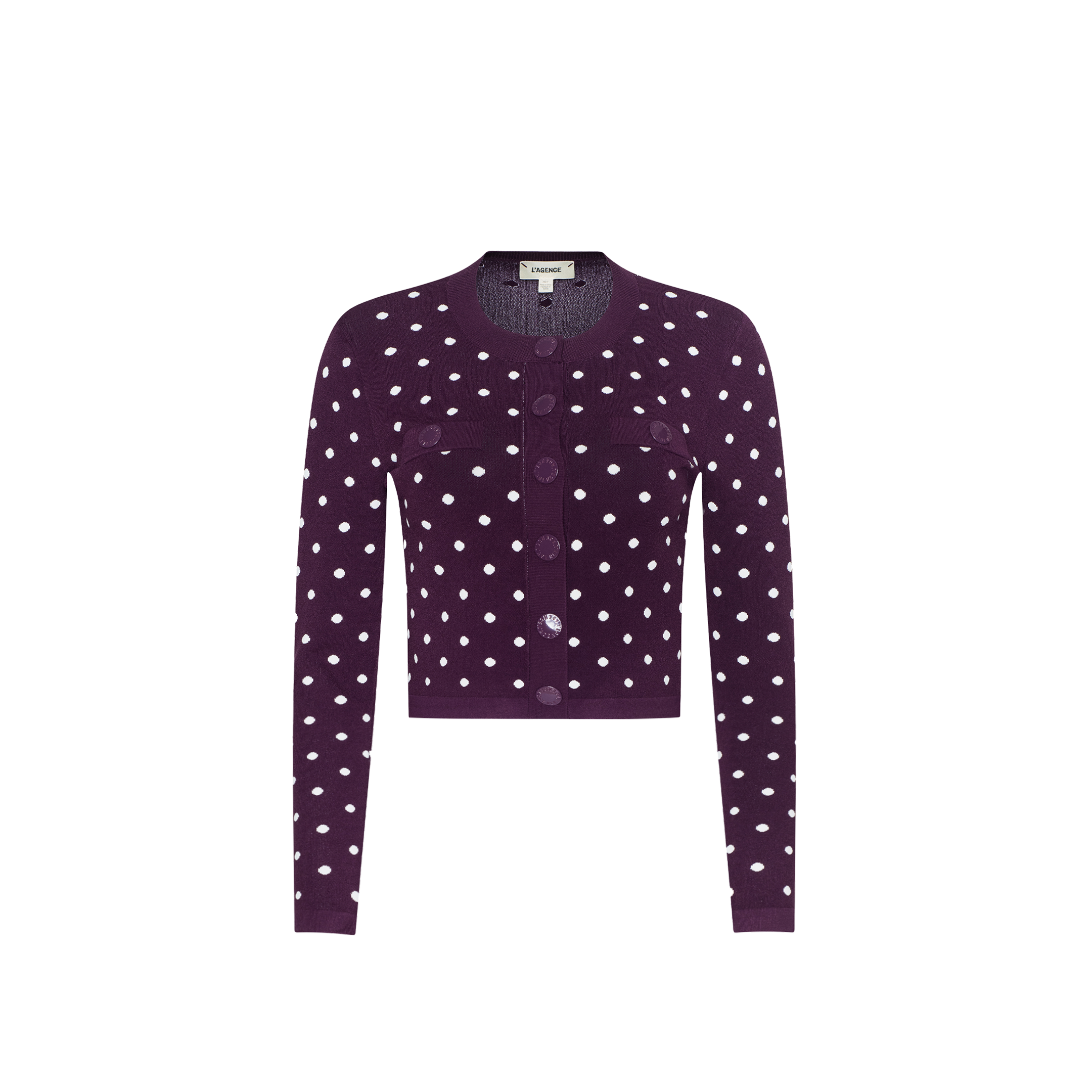 The Kota Cardigan Top, a dark purple long-sleeve essential cardigan featuring white polka dots, front buttons, and two chest pockets, is displayed on a plain white background.