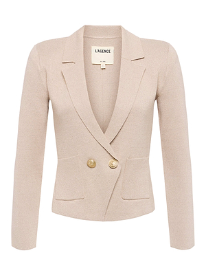 The Sofia Knit Blazer by L’AGENCE is a beige double-breasted blazer with long sleeves, peaked lapels, two front flap pockets, and two gold buttons. The label inside the collar reads L'AGENCE.