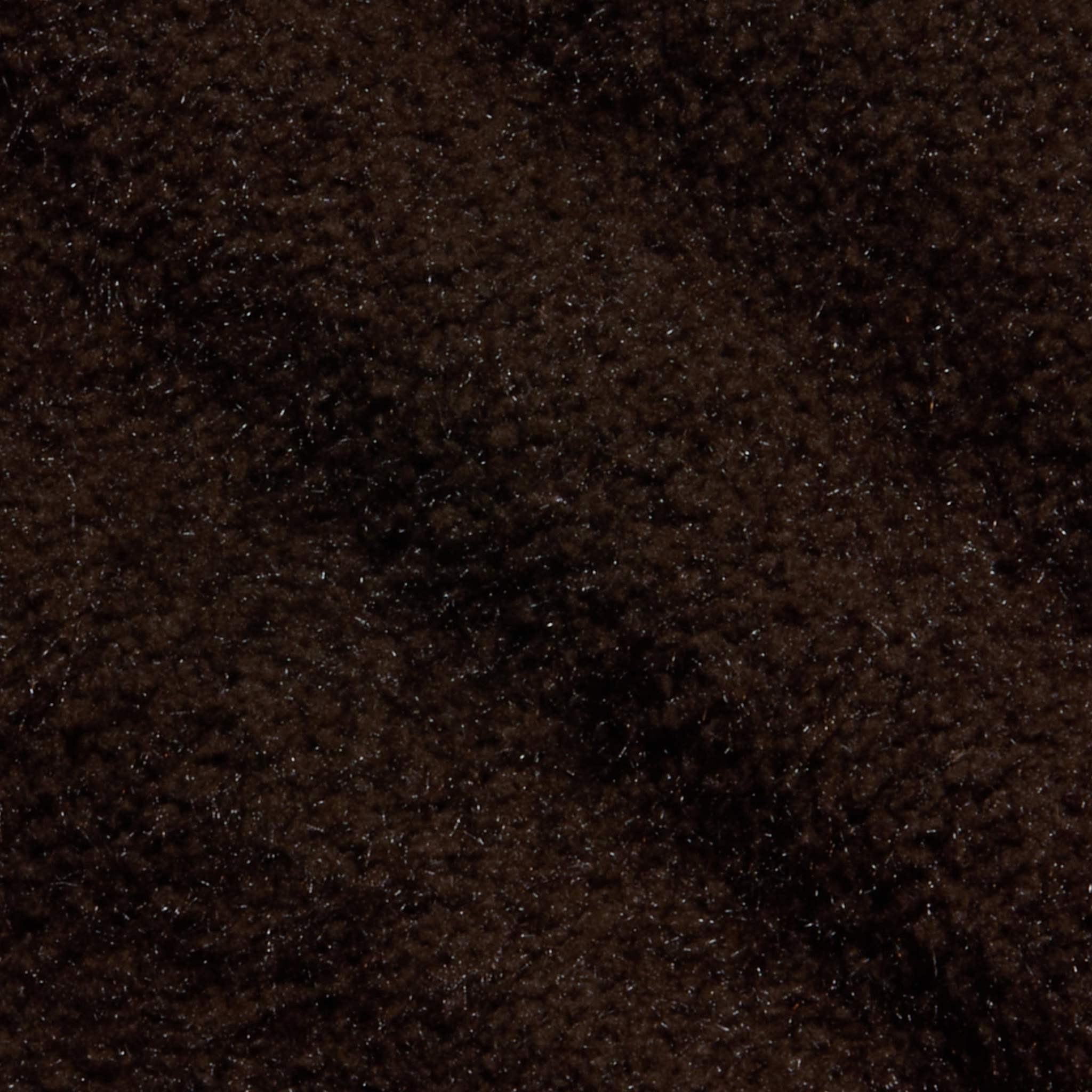 Close-up of the Salem Knit Skirt in dark brown, featuring a soft and fuzzy texture with gentle shadows and highlights that evoke the cozy feel of plush or fleecy fabric.
