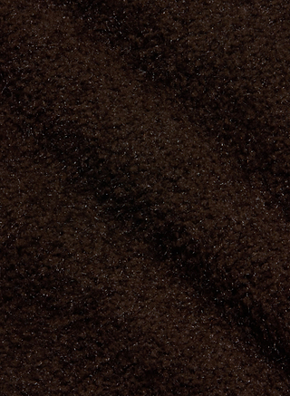 Close-up of the Salem Knit Skirt in dark brown, featuring a soft and fuzzy texture with gentle shadows and highlights that evoke the cozy feel of plush or fleecy fabric.