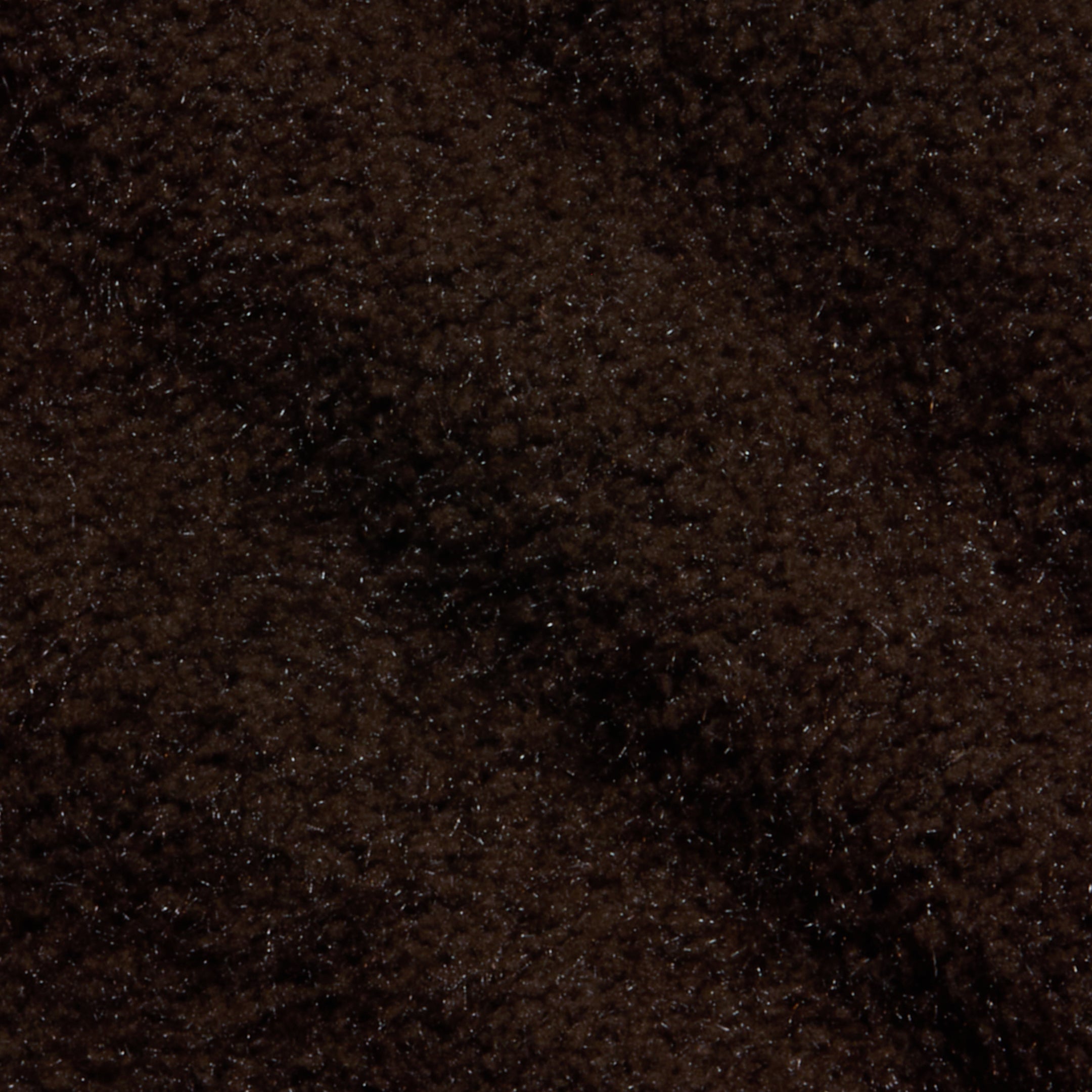 Close-up of the Salem Knit Skirt in dark brown, featuring a soft and fuzzy texture with gentle shadows and highlights that evoke the cozy feel of plush or fleecy fabric.