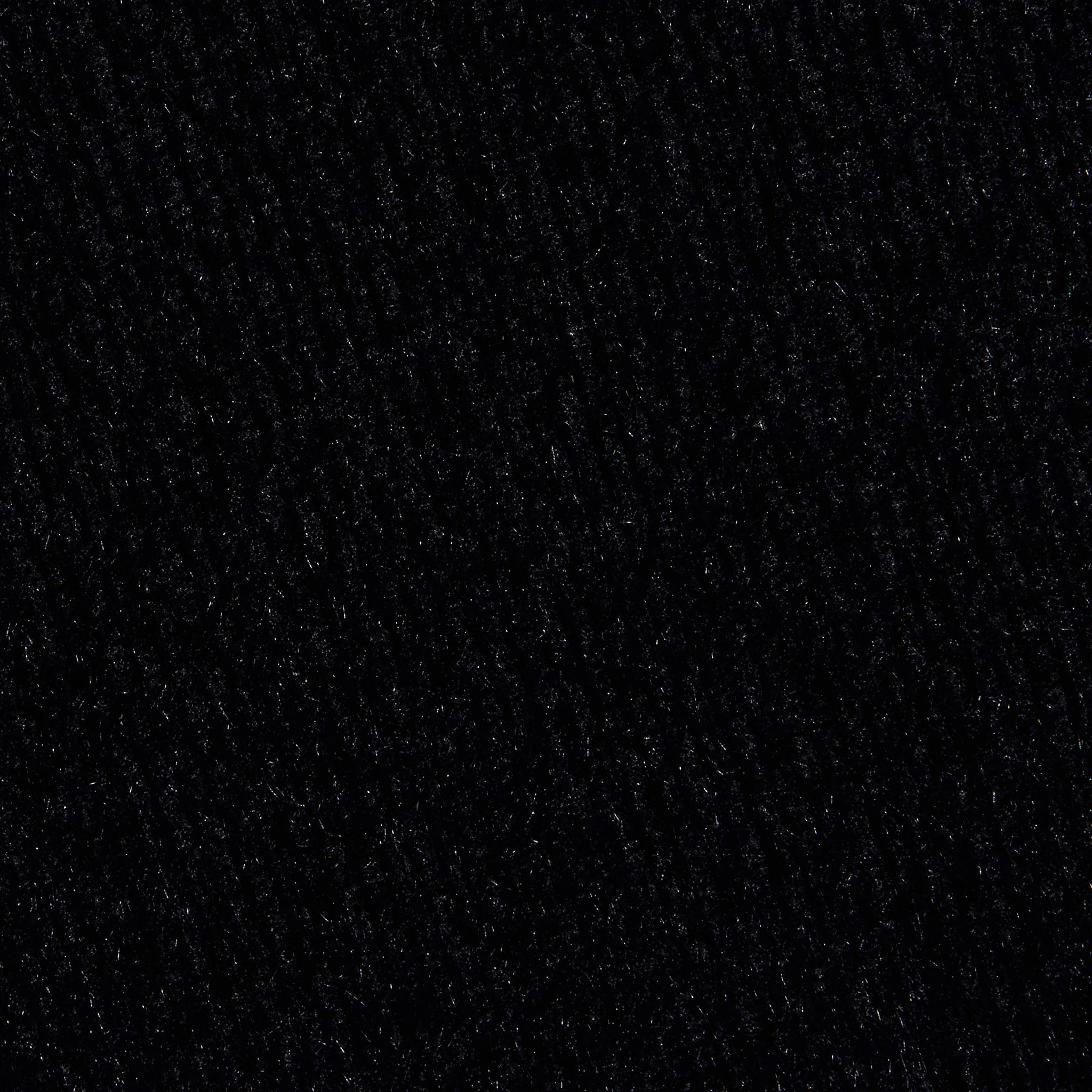 Close-up of the Guinevere Cropped Pullover in black, showcasing its ultra soft knit texture with subtle lines and patterns that lend a slightly rough and tactile appearance.