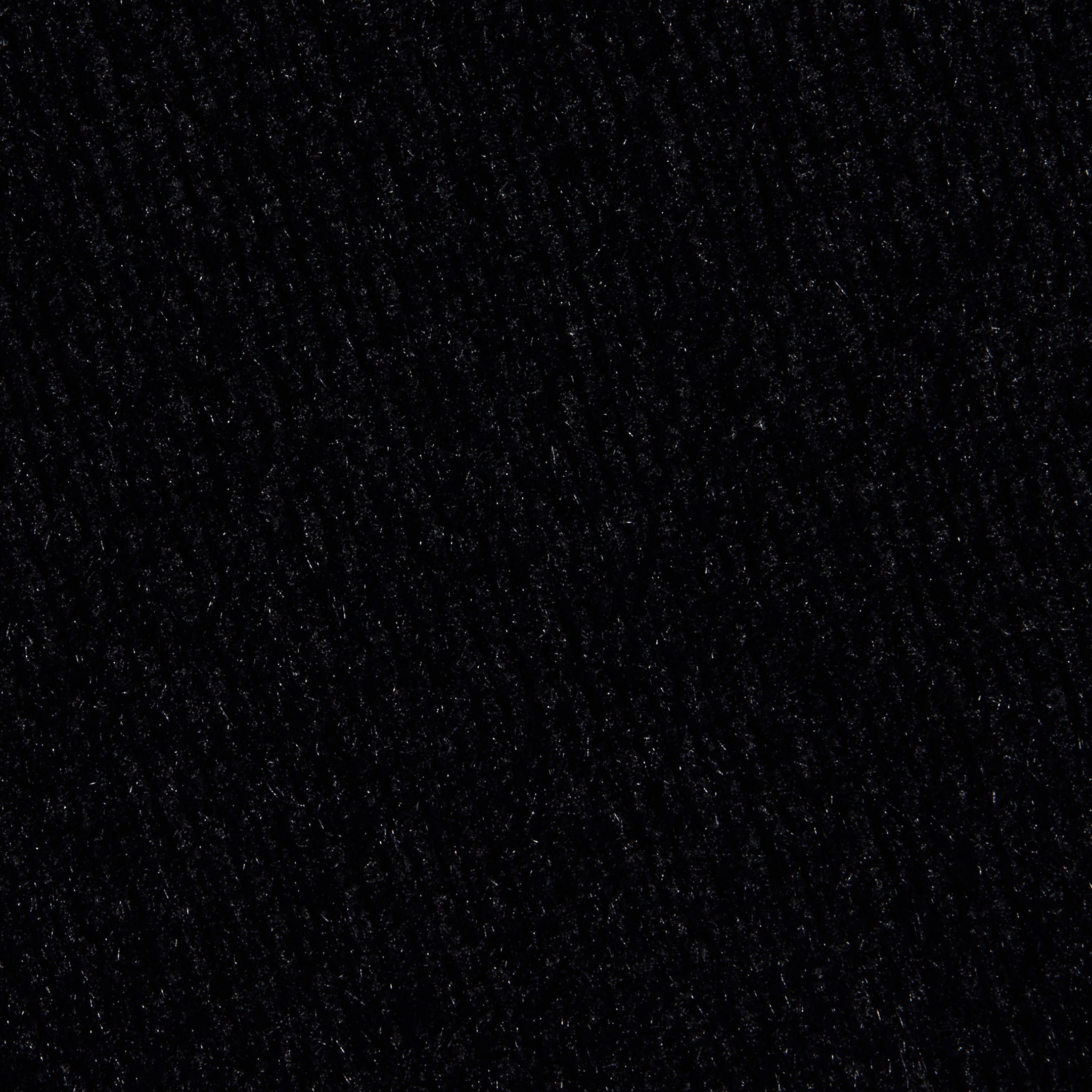 Close-up of the Guinevere Cropped Pullover in black, showcasing its ultra soft knit texture with subtle lines and patterns that lend a slightly rough and tactile appearance.