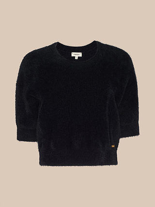 The Guinevere Cropped Pullover is an ultra soft black knit crewneck sweater featuring short sleeves and a cropped silhouette, showcased against a plain beige background.