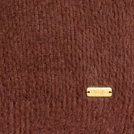 Close-up of the Guinevere Cropped Pullover, featuring ultra-soft brown knit fabric and a small rectangular gold tag in the bottom right corner displaying the brand name LAGENCE.