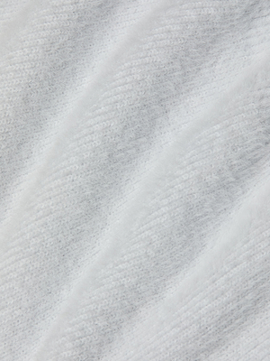 Close-up of the Guinevere Cropped Pullover, showcasing its soft, white, fluffy ribbed fabric. The cozy, diagonal texture highlights the plush feel of this stylish crewneck sweater.