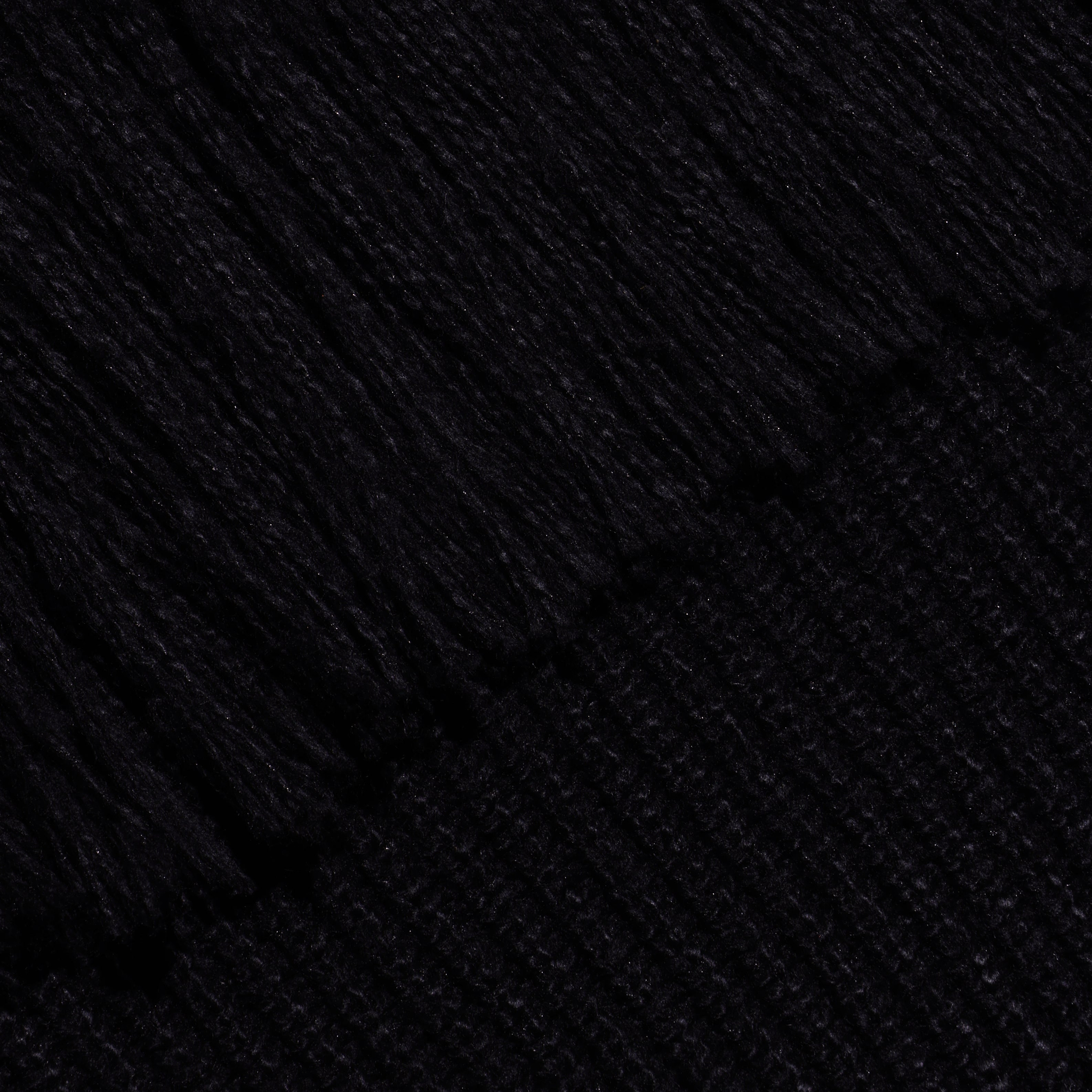 Close-up of the black Maddison Turtleneck, showing the ribbed texture of the cropped collar and the smooth knit of the body.