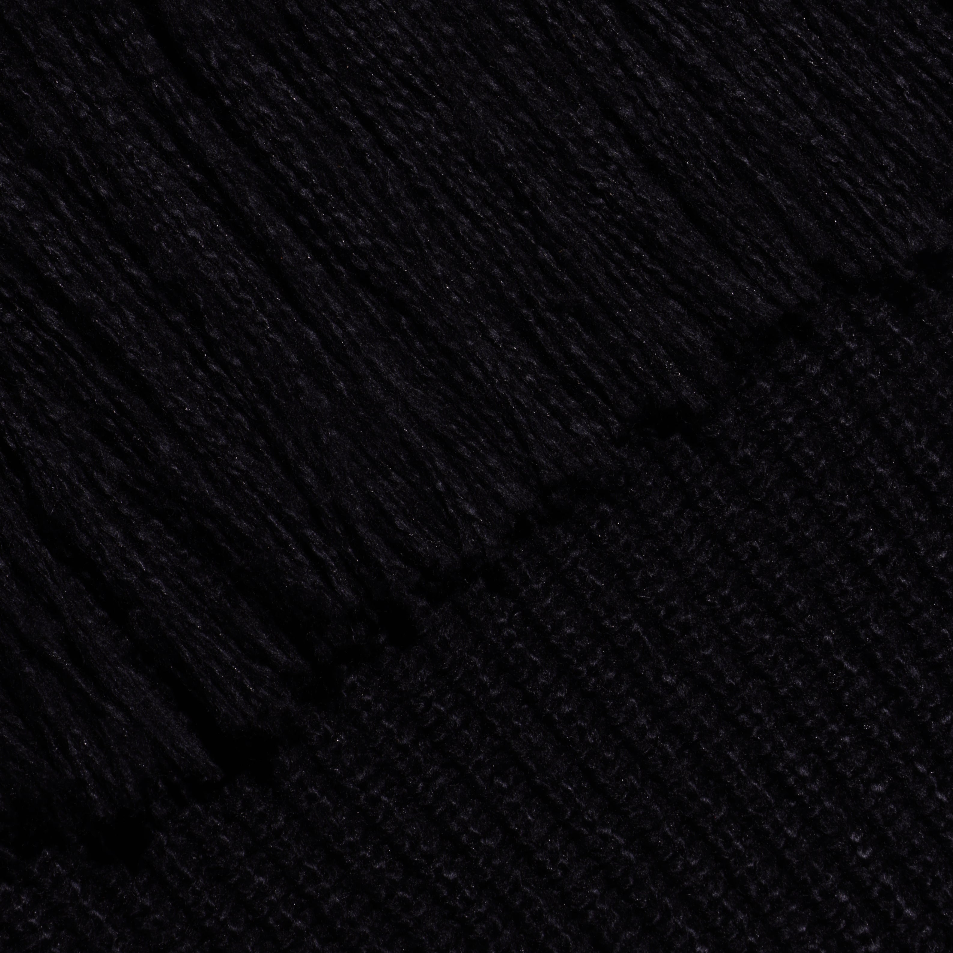 Close-up of the black Maddison Turtleneck, showing the ribbed texture of the cropped collar and the smooth knit of the body.