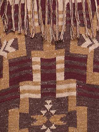 A close-up of the Jair Cardigan showcases brown, maroon, and beige geometric patterns with fringe at the top. Reminiscent of boho-chic style, this design features symmetrical shapes and star-like motifs.
