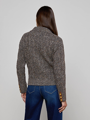 A person with long brown hair, shown from the back, wears the L'AGENCE Shiloh Cable Knit Cardigan and blue jeans.