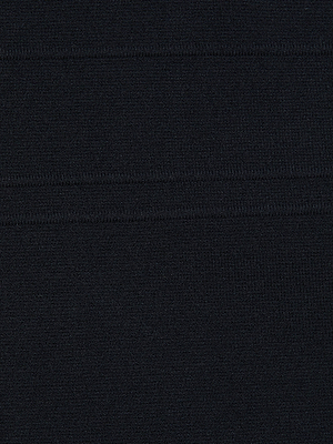 A close-up of black fabric with a subtle horizontal ribbed texture and visible stitching, perfect for the Jimena Knit Dress that shapes a sculpted silhouette.