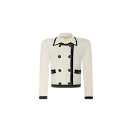 Janu Cropped Knit Jacket: A white double-breasted knit jacket featuring black trim, two front pockets, black cuffs, dark buttons, and a collared neckline. The structured silhouette is enhanced with removable shoulder pads.