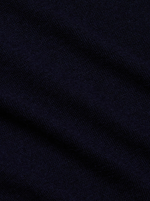 Close-up of the Kolie Chain Top in dark navy blue textured fabric with soft folds and a slightly fuzzy surface, suggesting a warm, cozy feel—perfect for this V-neckline knit style.