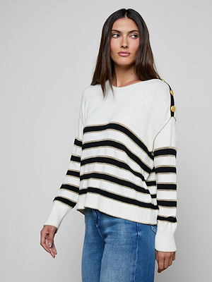 A woman with long brown hair models the Bishop Striped Sweater, featuring gold shoulder buttons, paired with blue jeans against a plain light background.